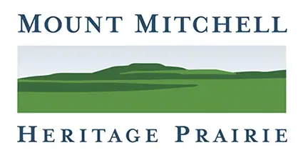 mount-mitchell-heritage-park-logo-2 Mount Mitchell Heritage Park logo with stylized blue sky and layered green mountain.